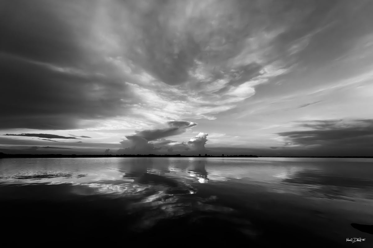 Black and white print of the August 8, 2026 Merritt Island Wildlife Refuge sunrise, glassy water reflecting clouds