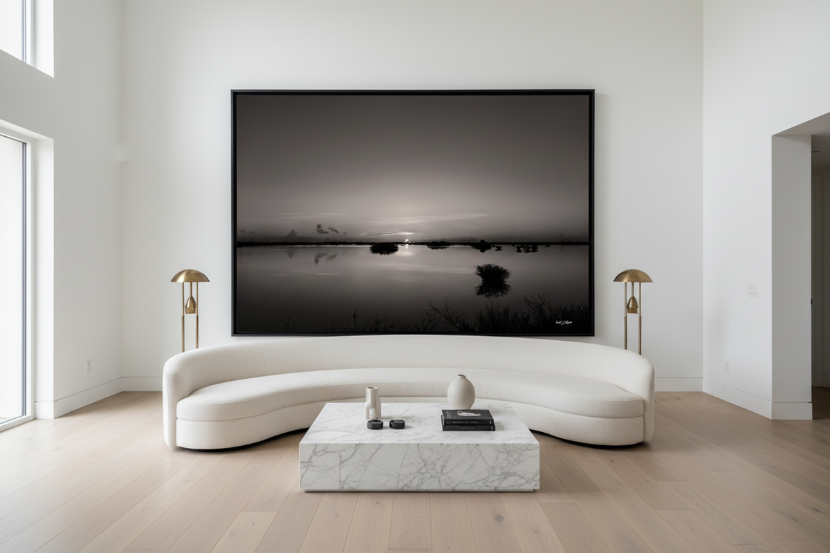 Black and white print of the July 3, 2026 Merritt Island, Florida sunrise displayed in a luxury living room